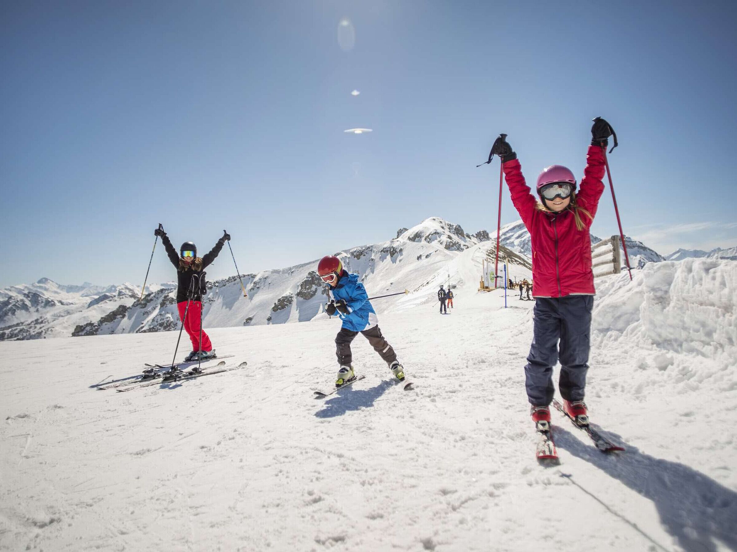 A snowy ski slope with skiers.
