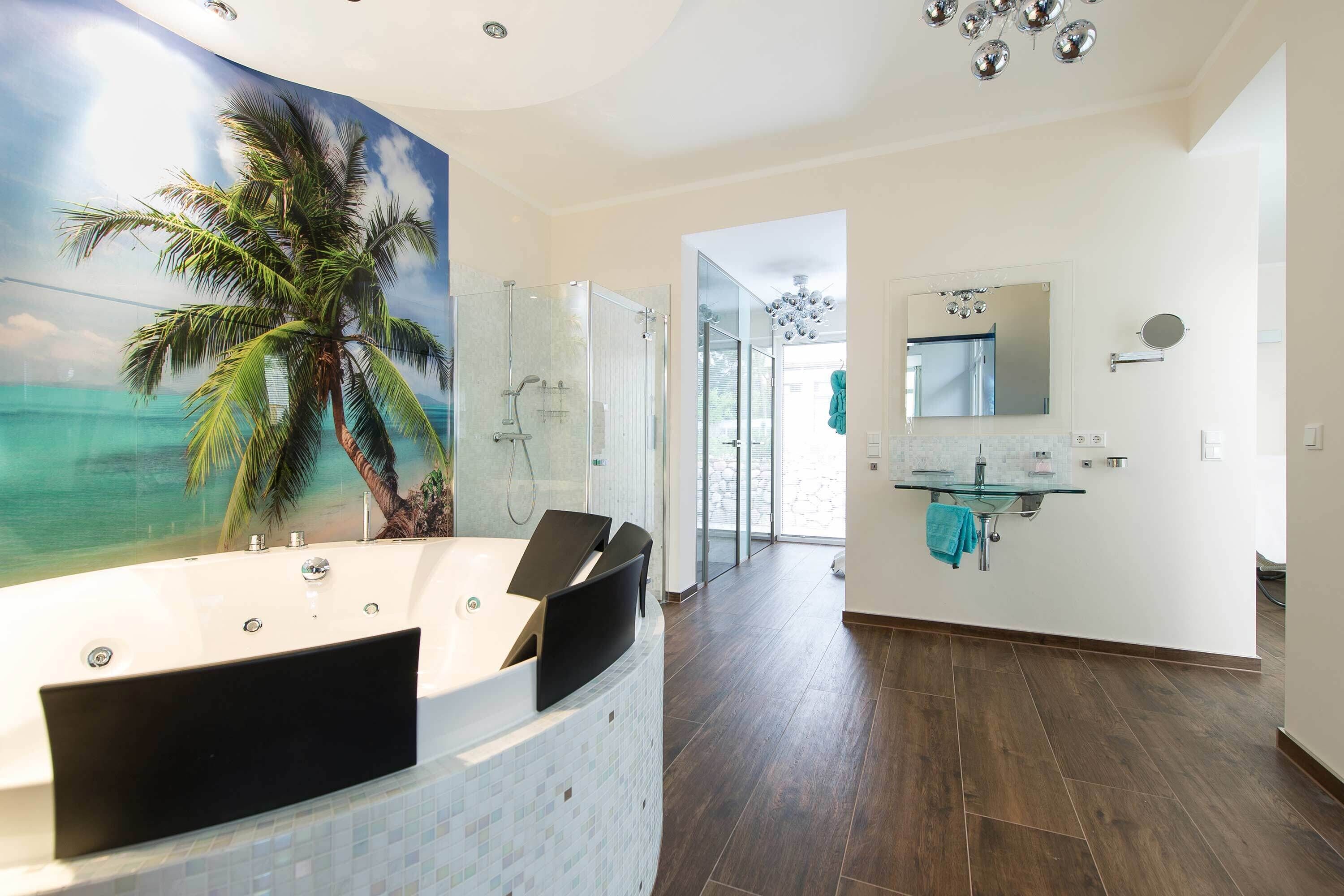 A modern bathroom with a glass shower enclosure, a large mirror, and a view of the ocean through a glass door.