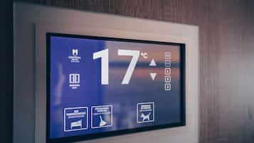 A digital display with the temperature reading of 17°C, a hotel logo, and icons for room status and cleaning instructions.