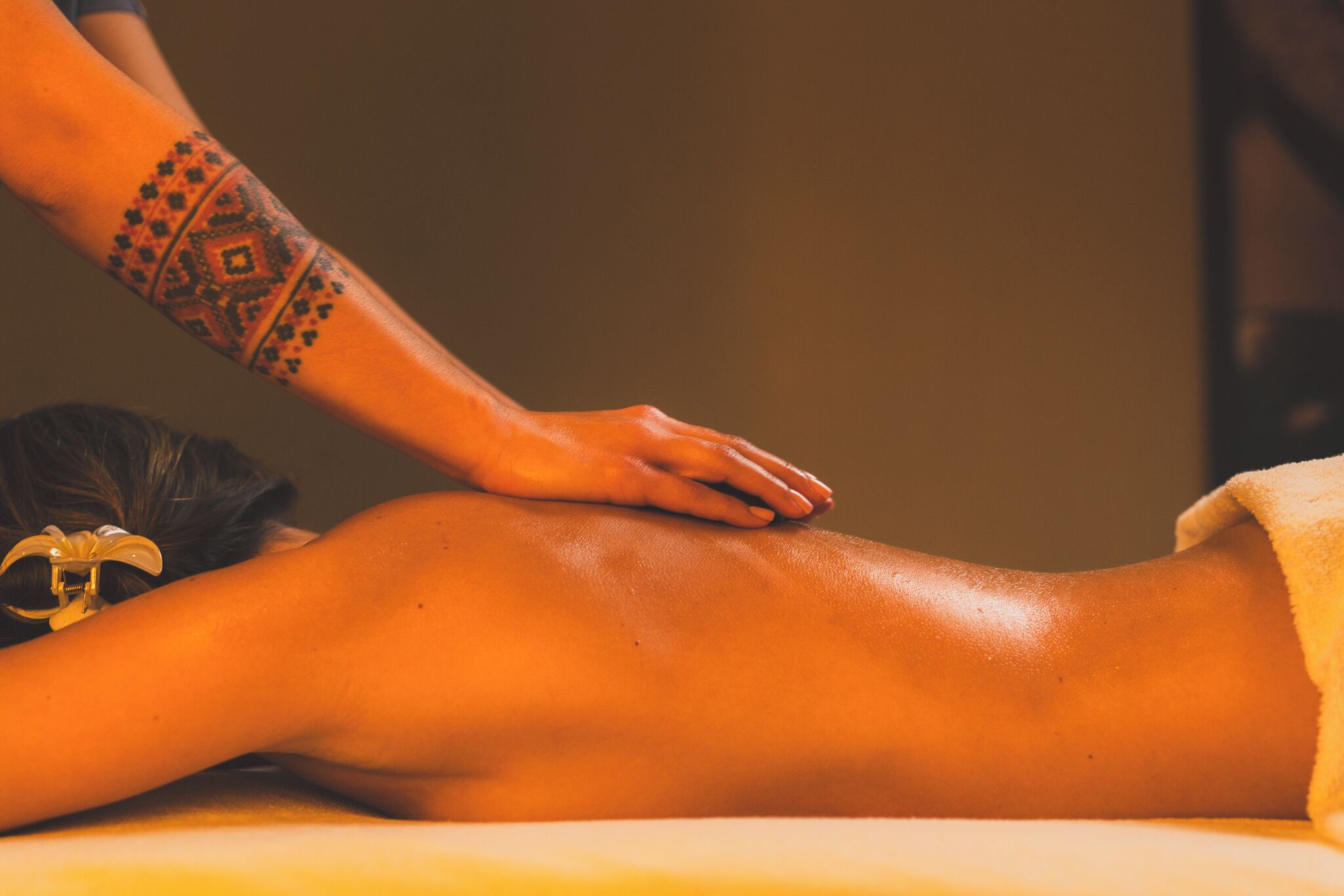 A person receiving a massage on a massage table.