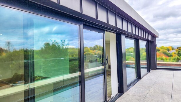 A modern building with large glass windows and a flat roof. - Manchester's skyline Sanctuary-Bedroom Luxury Penthouse with Panoramic CityViews (Manchester)