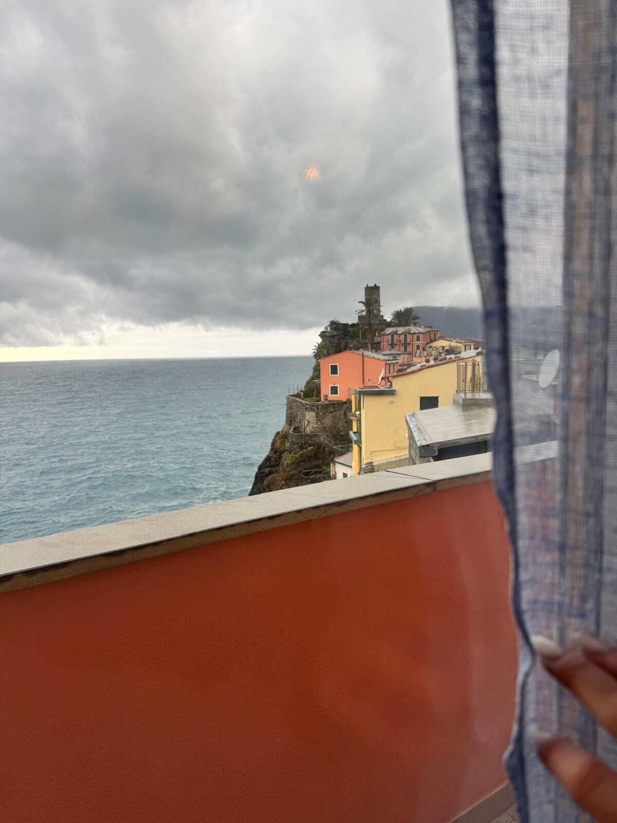 A coastal view with buildings on a cliff overlooking the sea.