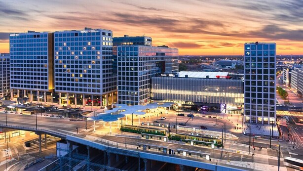 A modern urban area with high-rise buildings, a central plaza, and a bridge. - Sauna, balcony, wifi, trainstation, Mall of Tripla (Helsinki)