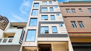 A multi-story hotel with a modern facade, large windows, and a visible entrance. - Hotel Silver Palace (Kanpur)