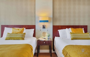 A hotel room with two beds, a nightstand, a lamp, and a small table with a plant. - Beautiful Studio w/Private Balcony + Amazing Pool (Sunny Isles Beach)