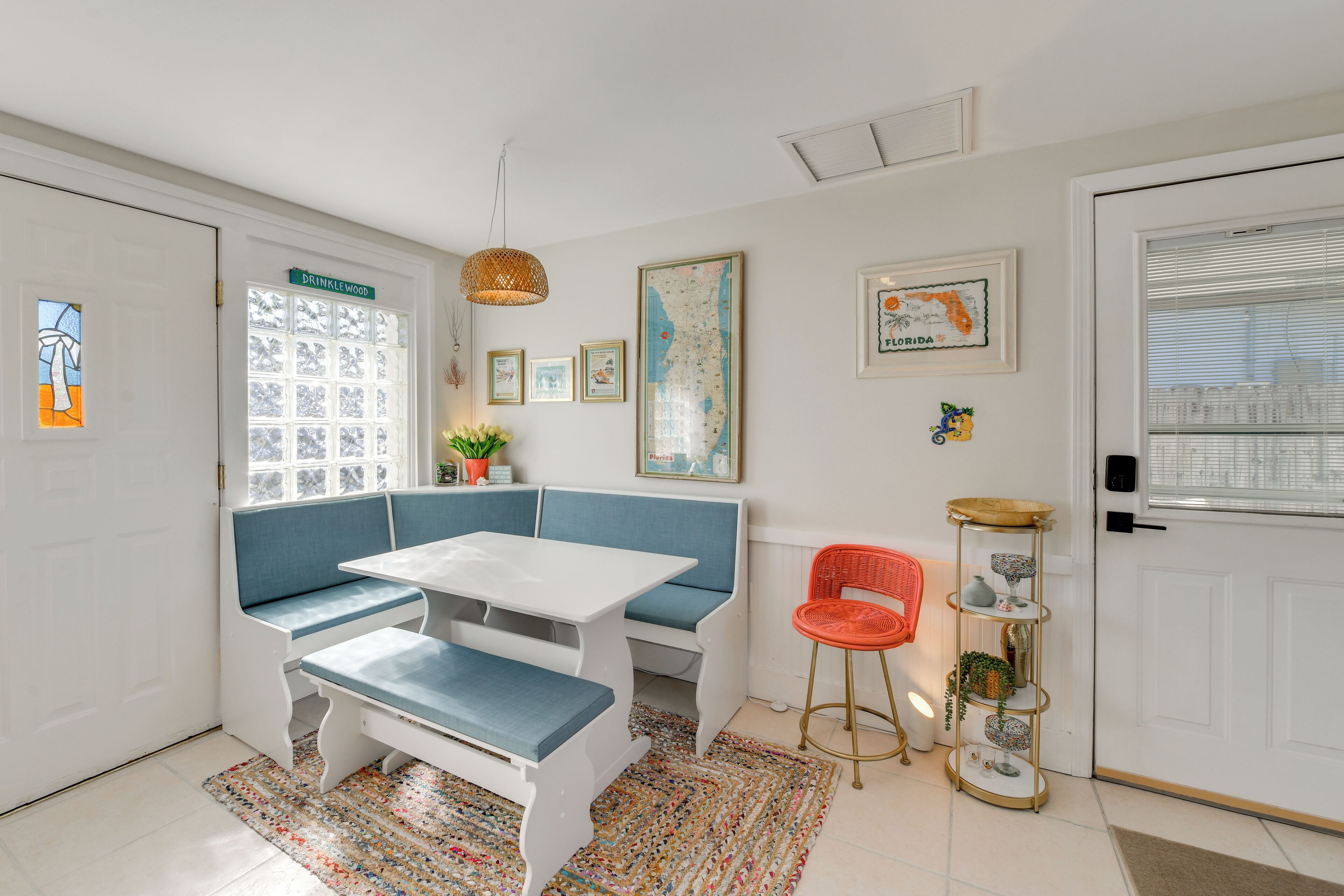 A cozy room with a bench, table, and a small plant.
