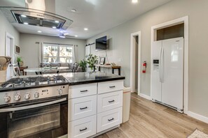 A modern kitchen with a gas stove, oven, white cabinetry, and a built-in microwave. - World Cup HQ Near Stadium, 1 Mi to Beltline Access (Atlanta)