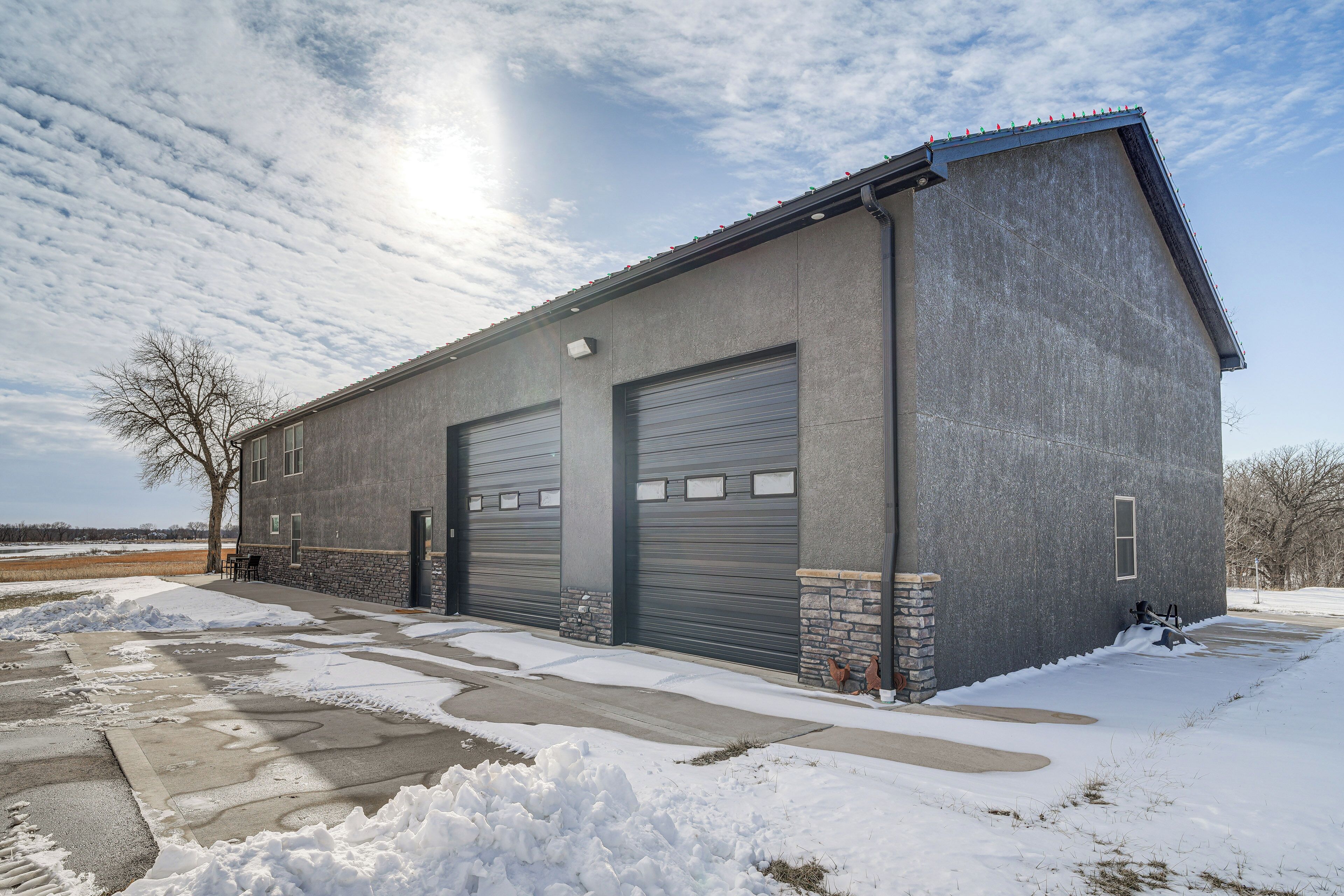 A two-story building with a garage and a driveway.