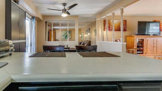 A kitchen with a white countertop, a ceiling fan, and wooden cabinets. - 4 Mi to Dtwn Loveland: Home w/ Hot Tub & Yard (Loveland)
