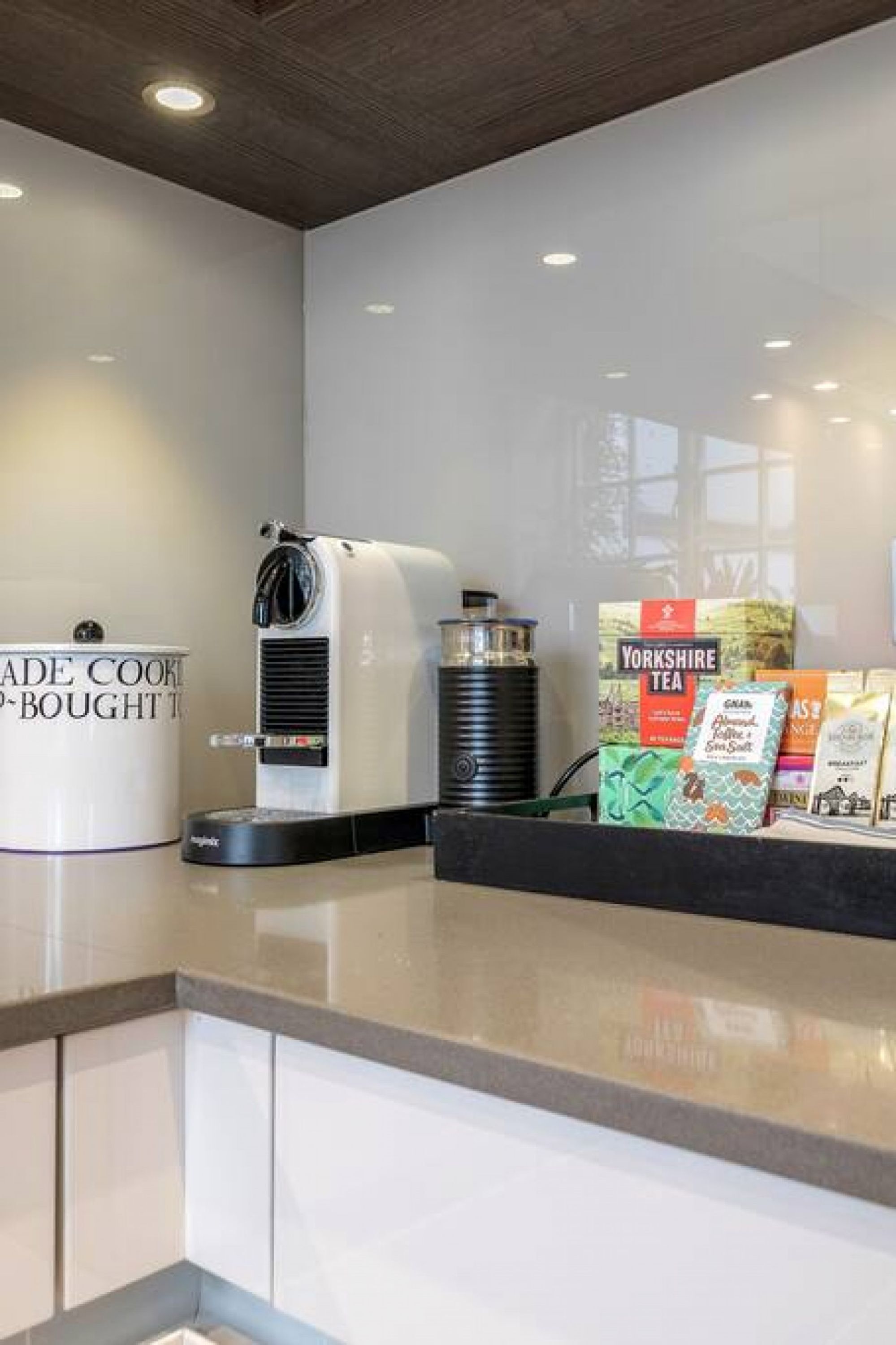 A kitchen area with a coffee machine, a kettle, and a Yorkshire Tea display.