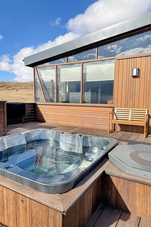 A wooden deck with a hot tub and a bench. - Valey Countryside Escape (Hvammstangi)