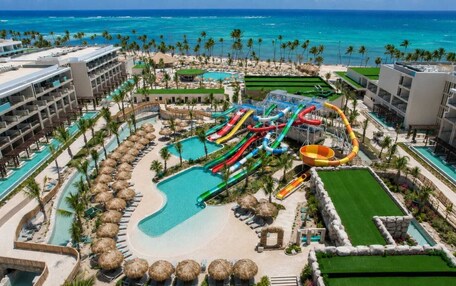 A resort with a water park, multiple swimming pools, and beachfront views.