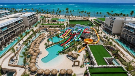 A resort with a water park, multiple swimming pools, and beachfront views.