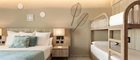 A hotel room with a bed, bedside tables, a nightstand, a lamp, and a bunk bed.