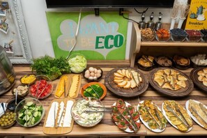 A buffet with various food options including salads, sandwiches, and baked goods. - ECO ART Hotel (Tashkent)