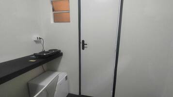 Economy Studio Suite | Bathroom | Shower, towels, toilet paper