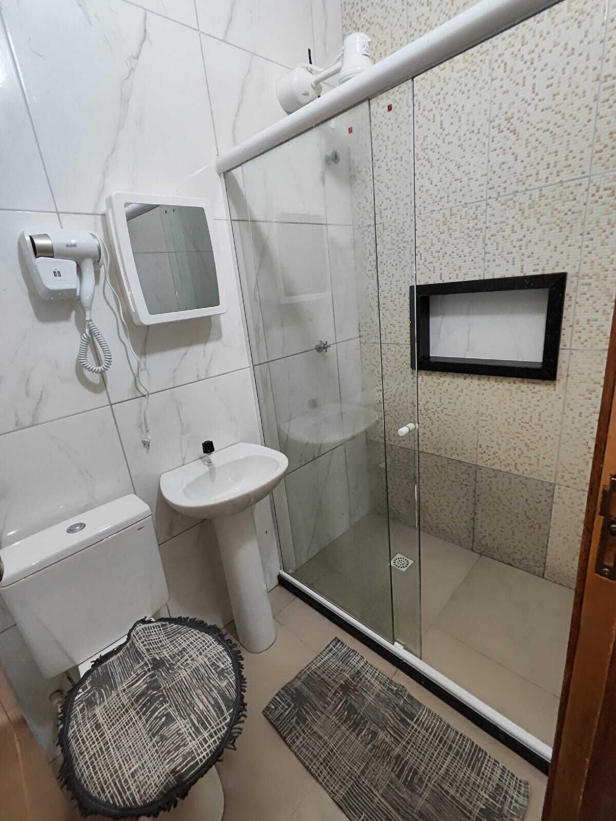Shower, hair dryer, soap, toilet paper