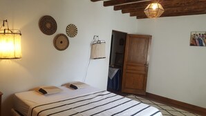 A bedroom with a bed, a hanging light fixture, and a wooden wardrobe. - Mas du Coustoubi between Avignon and St Remy. Swimming pool, Pétanque, BBQ (Châteaurenard)
