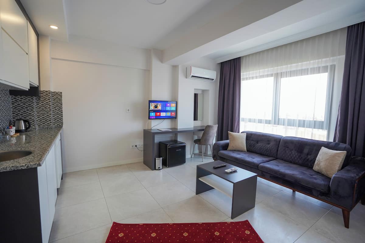 A modern living room with a sofa, coffee table, and TV.