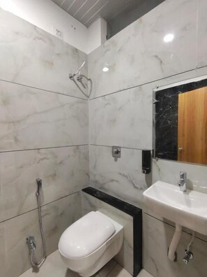 Deluxe Triple Room, City View | Bathroom | Shower, free toiletries, hair dryer, slippers - Hotel Tirupati Inn (Ujjain)