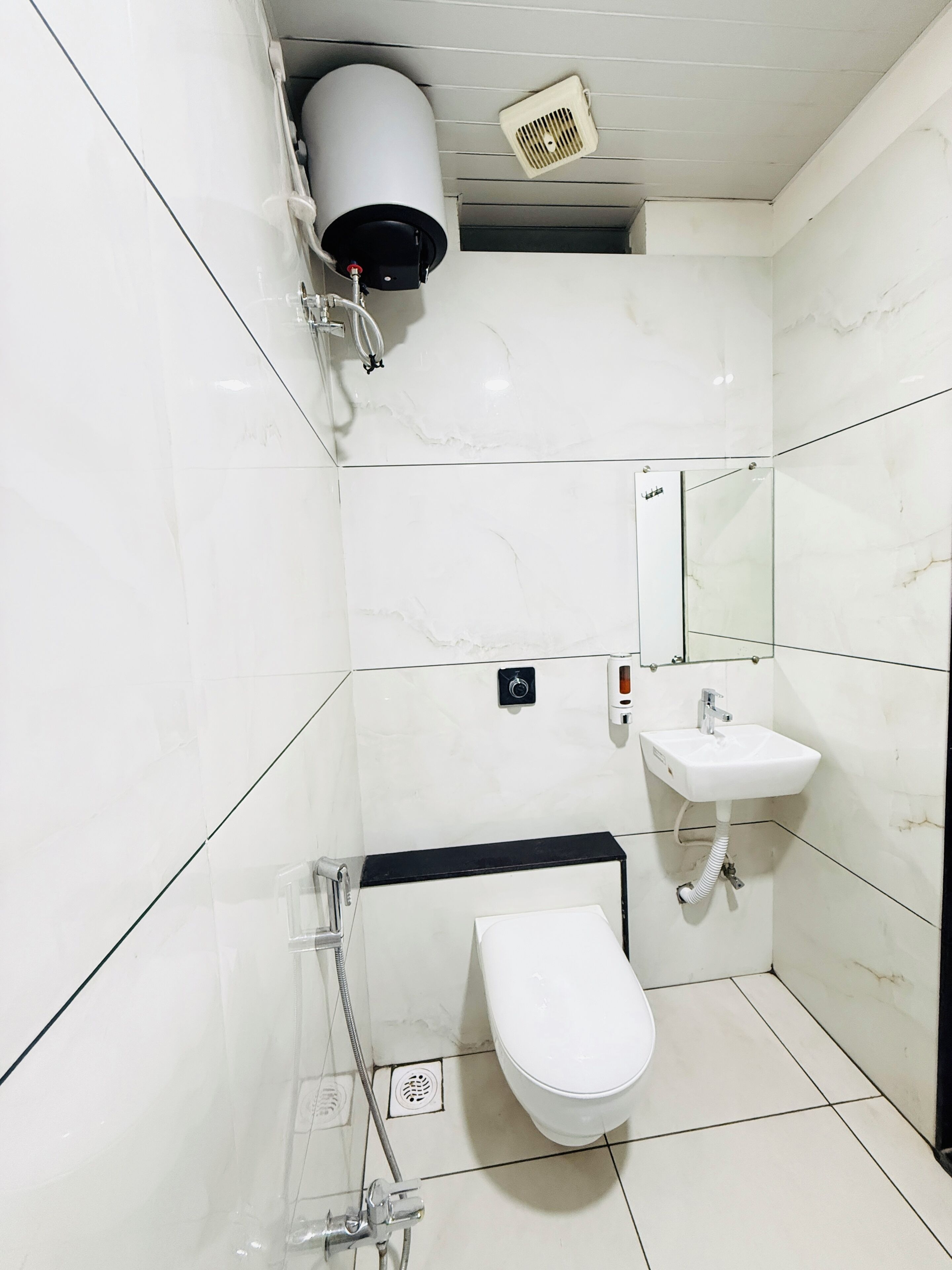 A modern bathroom with a toilet, sink, and shower.