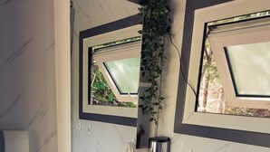 A bathroom with a white sink, a mirror, and a window. - Spacious Bell Tent with Private Deck & Forest Access near Carson, Washington (Carson)