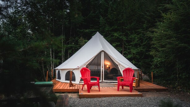 A tent with a wooden deck and two red chairs. - Spacious Bell Tent with Private Deck & Forest Access near Carson, Washington (Carson)