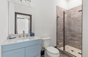 Shower, hair dryer, towels, toilet paper