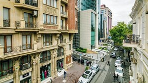 Un edificio de varios pisos con fachada clásica, que presenta balcones ornamentados y ventanas grandes.