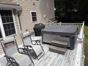 A deck with outdoor furniture, a grill, and a hot tub. - Half-Acre Coastal Retreat- Hot tub and walk to town! (Ogunquit)