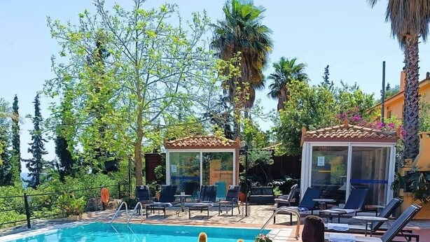 Ein Pool mit Liegestühlen und einer Kakteengarten.