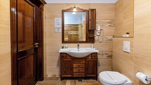 A bathroom with a wooden vanity, a white sink, and a toilet. - HOTEL DIESEL (Bucharest)