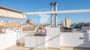 A rooftop terrace with a view of a mountain and cityscape, featuring a white wall, a pergola, and a water feature. - CostaBlancaDreams - Casa Paquita in Calpe (Calpe)