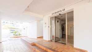 A modern building entrance with a tiled floor, a glass door labeled "EUROPA-11", and a small plant by the entrance. - CostaBlancaDreams - Europa 2 in Calpe (Calpe)