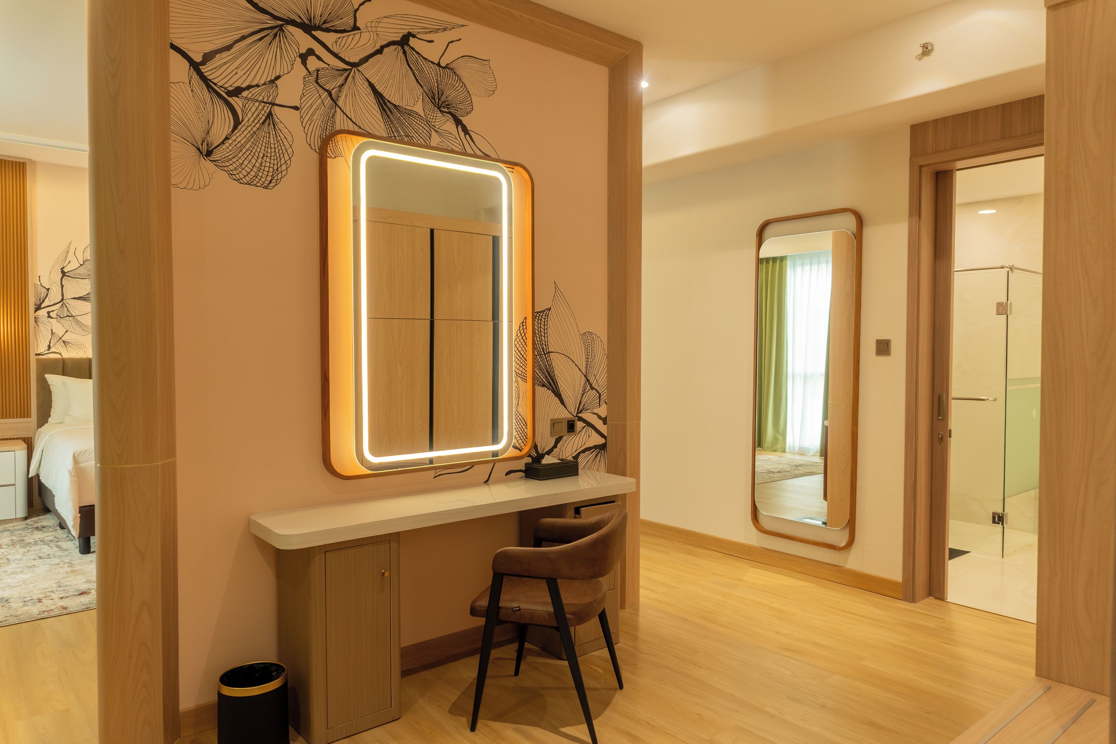 A modern bathroom with a large mirror, a vanity, and a shower area.