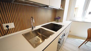 Mini-fridge, stovetop, cookware/dishes/utensils