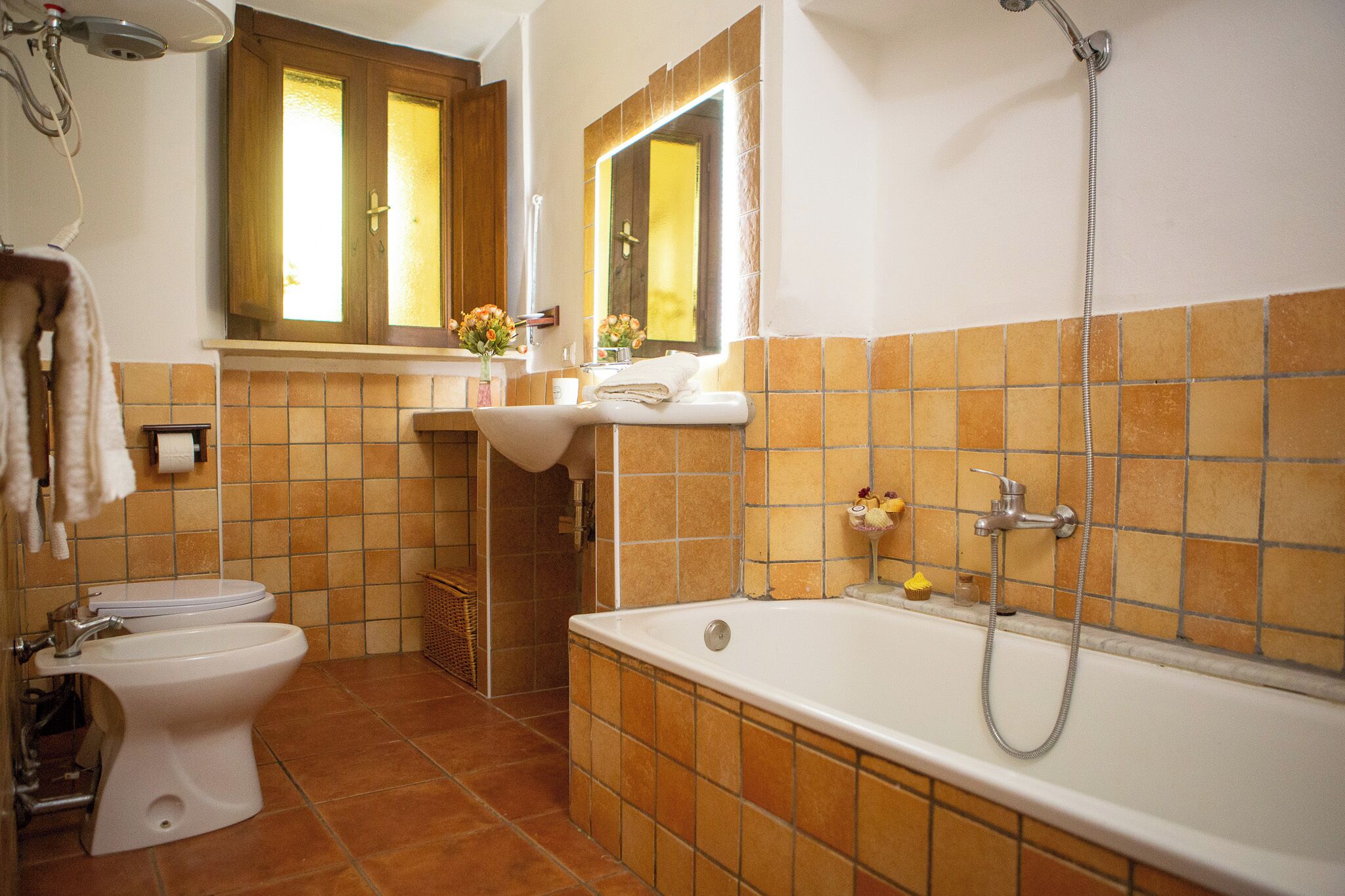 A bathroom with a toilet, sink, and bathtub.