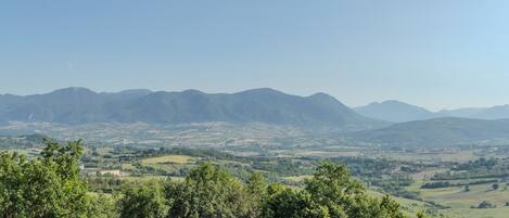 A panoramic view of a mountainous landscape with a clear sky.