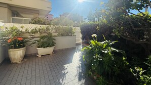 A rooftop garden with potted plants, a white fence, and a clear sky. - GRAZIELLA - Fronte Mare in Centro con terrazza (Marina di Andora)
