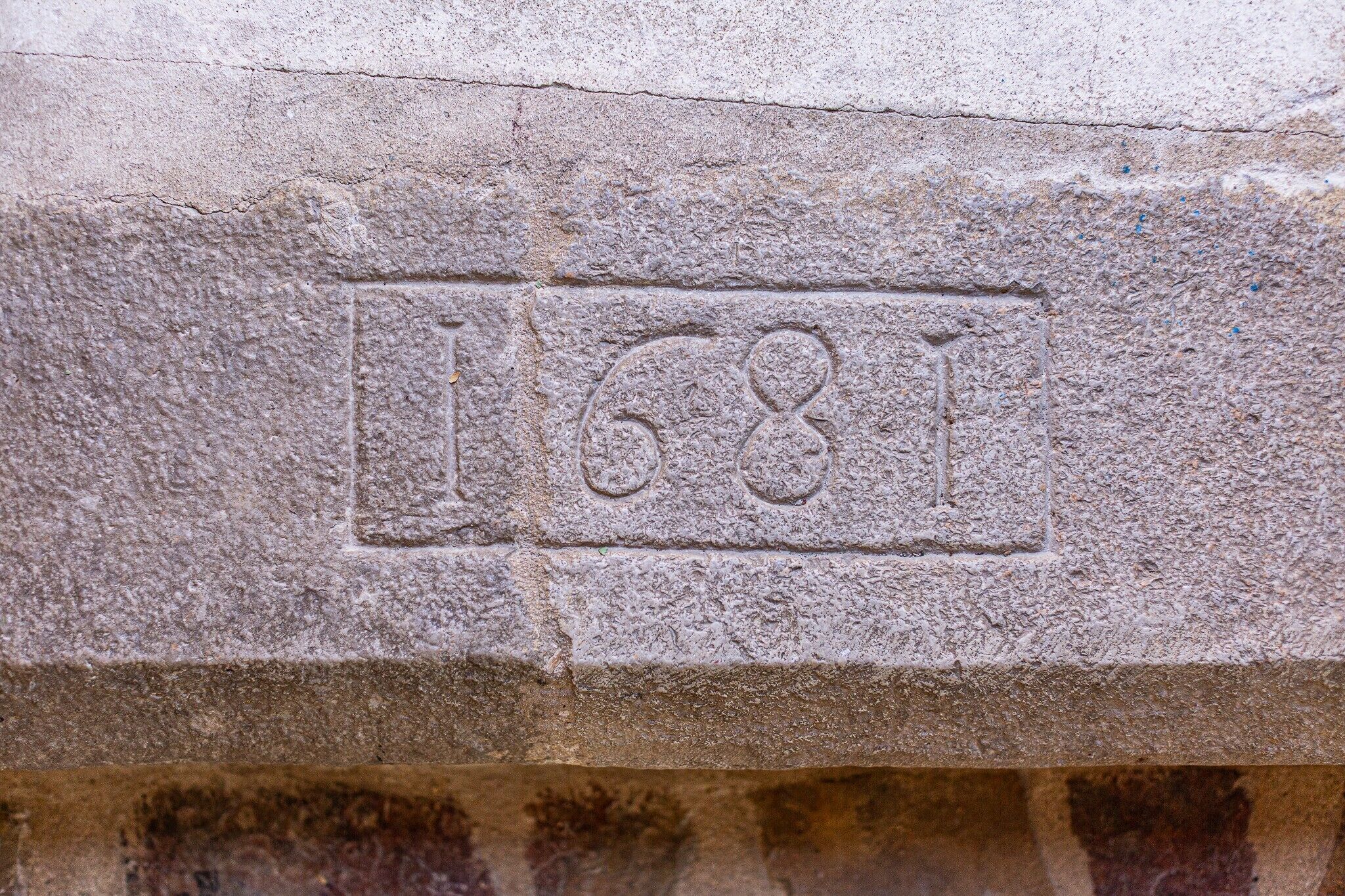 Eine Steinmauer mit der eingravierten Jahreszahl 1681.