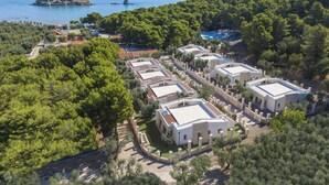 A coastal resort with multiple white buildings, a pool, and a view of the sea. - Gattarella - Ville al mare (Vieste)
