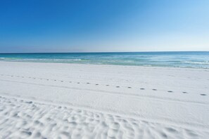 A beach with white sand and clear blue water. - Ariel Dunes 901 Gulf view condo in Destin at Seascape Resort (Miramar Beach)