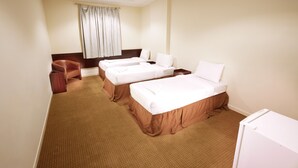 A hotel room with two beds, a desk, a chair, and a window with curtains. - Al Zaireen 2 (Makkah)