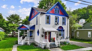 A two-story house with a porch, a front door, and a small front yard. - Sounds of the Waterfall - 1mi to Racetrack & Park (Montour Falls)