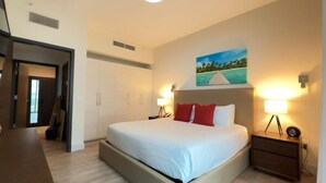 A modern bedroom with a large bed, a desk, and a wardrobe. - Rent Apart Hollywood (Hollywood)