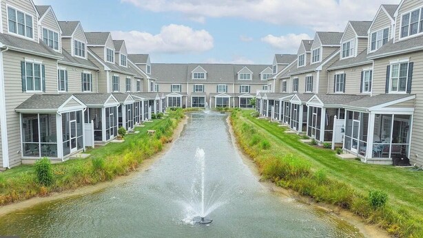 A row of modern, two-story houses with a central water feature and a well-maintained lawn. - Tastefully FULL furnished, 3 bedrooms with 3.5 bath townhouse. (Rehoboth Beach)