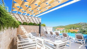 An outdoor seating area with white furniture, a pool, and a view of the landscape. - Villa High Life - Four Bedroom Villa, Sleeps 9 (Seget Vranjica)