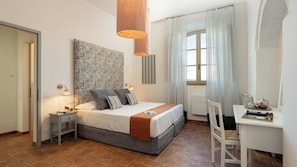 A bedroom with a bed, bedside tables, a desk, and a chair. - Villa Le Beringhe 30, Emma Villas (Colle di Val D'Elsa)