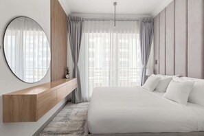 A modern bedroom with a large bed, a wooden console table, a round mirror, and sheer curtains. - Lux Dubai Marina apt | Canal View from bed rooms (Dubai)