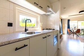 Fridge, microwave, coffee/tea maker, cookware/dishes/utensils